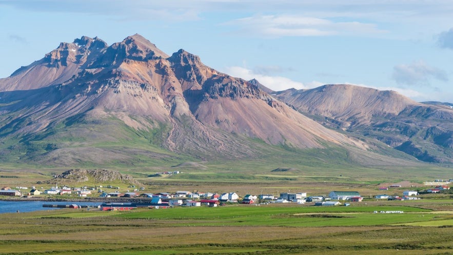 Bakkagerdi in Borgarfjordur Eystri with a mountain in the background under a blue sky