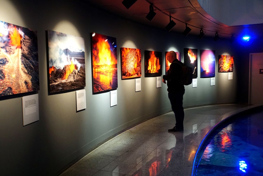 Visitor viewing a volcanic photography exhibition at Perlan in Reykjavik.