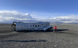 Electric fat bike rider exploring the DC-3 plane wreck area on Solheimasandur.