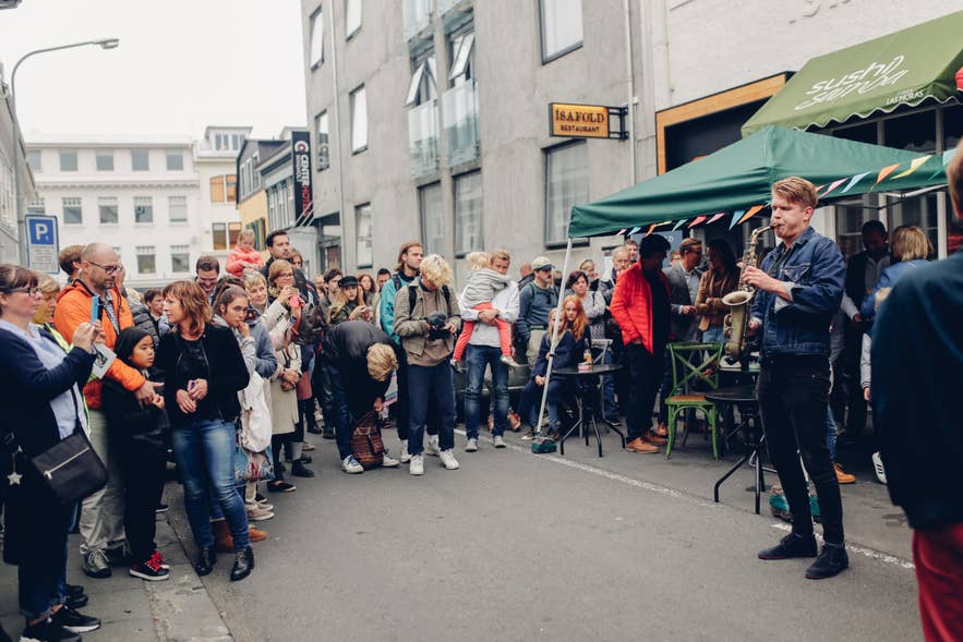 A saxophonist performs to a street crowd in downtown Reykjavík, a glimpse of Iceland's outsized music scene.