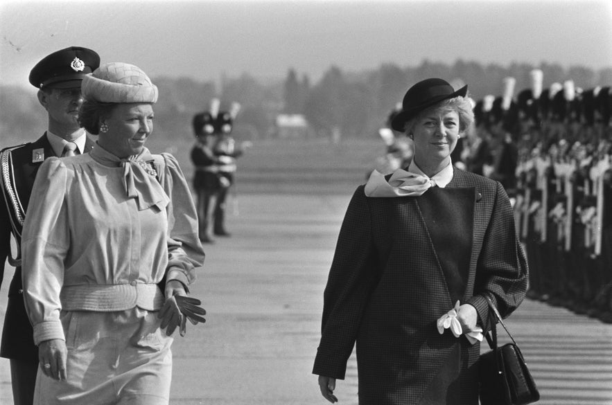 Two women in formal attire inspect a military honor guard during a ceremonial visit at Rotterdam Airport. Two women in formal attire inspect a military honor guard during a ceremonial visit at Rotterdam Airport.