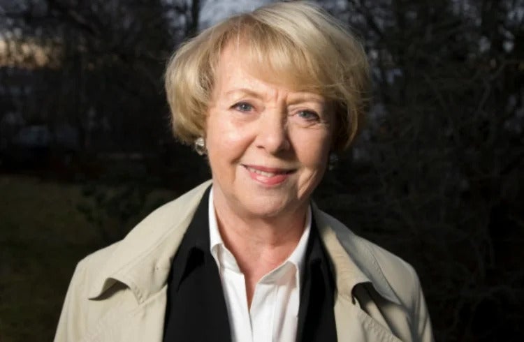 Vigd&iacute;s Finnbogad&oacute;ttir, former president of Iceland, smiles while standing outdoors in natural light.