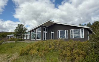 Freya Farm accommodation exterior surrounded by trees and nature in South Iceland.