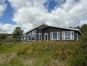 Freya Farm accommodation exterior surrounded by trees and nature in South Iceland.