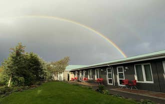 Rainbow over countryside landscape near Freya Farm in South Iceland.