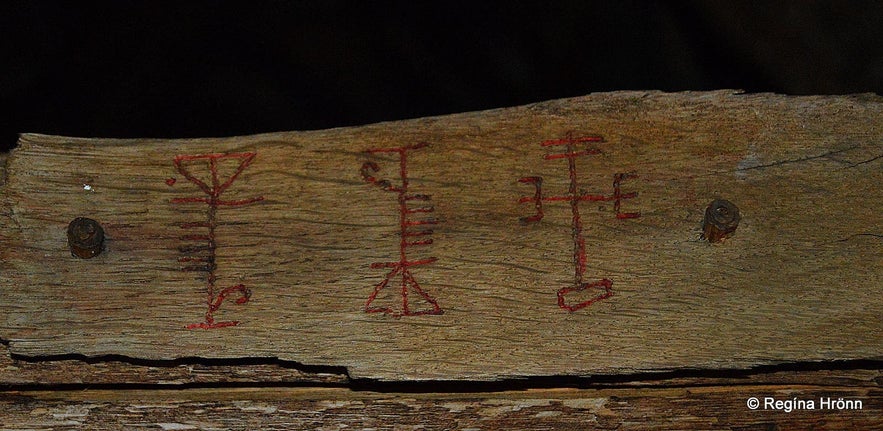 Icelandic magical staves carved into wooden plank at the Sorcerer&rsquo;s Cottage in the Westfjords, reflecting traditional folk magic