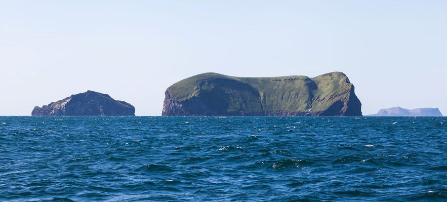 Vestmannaeyjar islands are characterized by their dramatic black cliffs rising from the ocean Vestmannaeyjar islands are characterized by their dramatic black cliffs rising from the ocean
