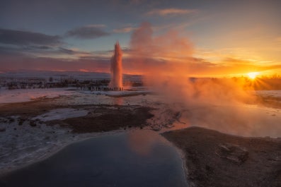 Strokkur geyser shoots boiling water in the Geysir geothermal area.