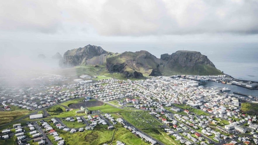 The town of Vestmannaeyjabaer has beautiful towering rocks above it