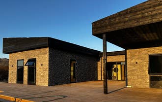 Spacious wooden deck with built-in hot tub at Golden Circle Luxury Villa in Iceland.