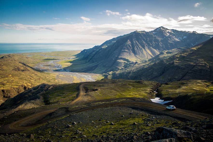 Iceland's Ring Road curving through mountains under a changing sky