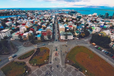 Reykjavik features colorful houses surrounded by a beautiful bay.