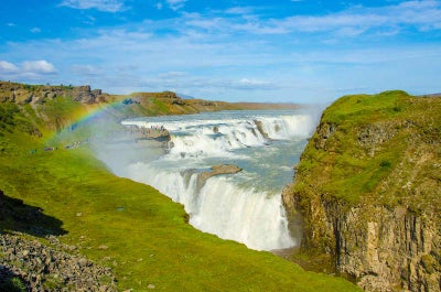 A rainbow shoots above the Gullfoss waterfall in the Golden Circle.