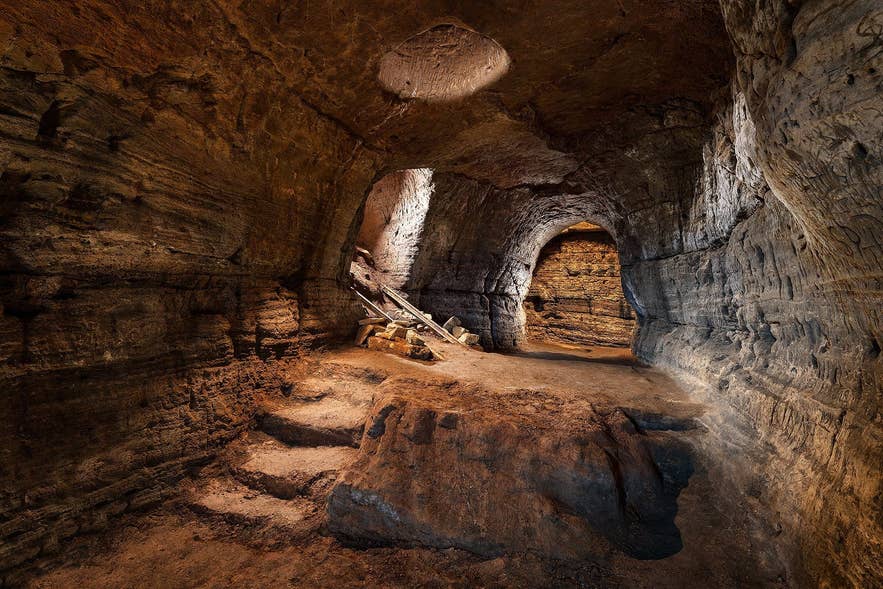 Vidgelmir Lava Cave interior in Hallmundarhraun, West Iceland, showcasing caves in Iceland with walkways.