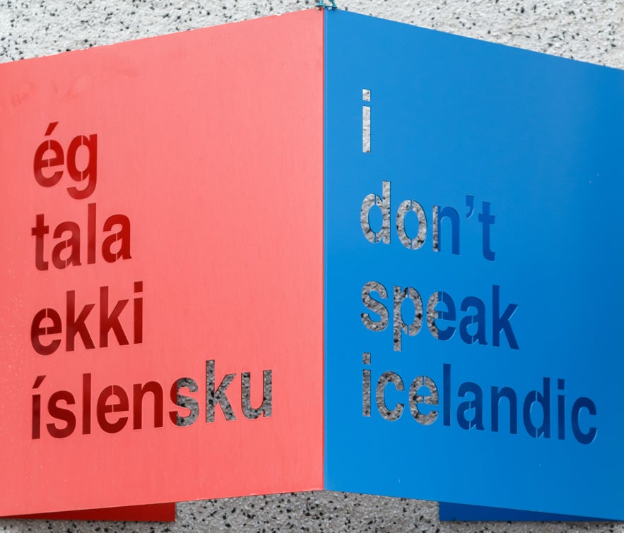 Red and blue sign with phrases in Icelandic alphabet and English