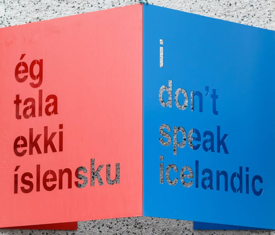 Red and blue sign with phrases in Icelandic alphabet and English