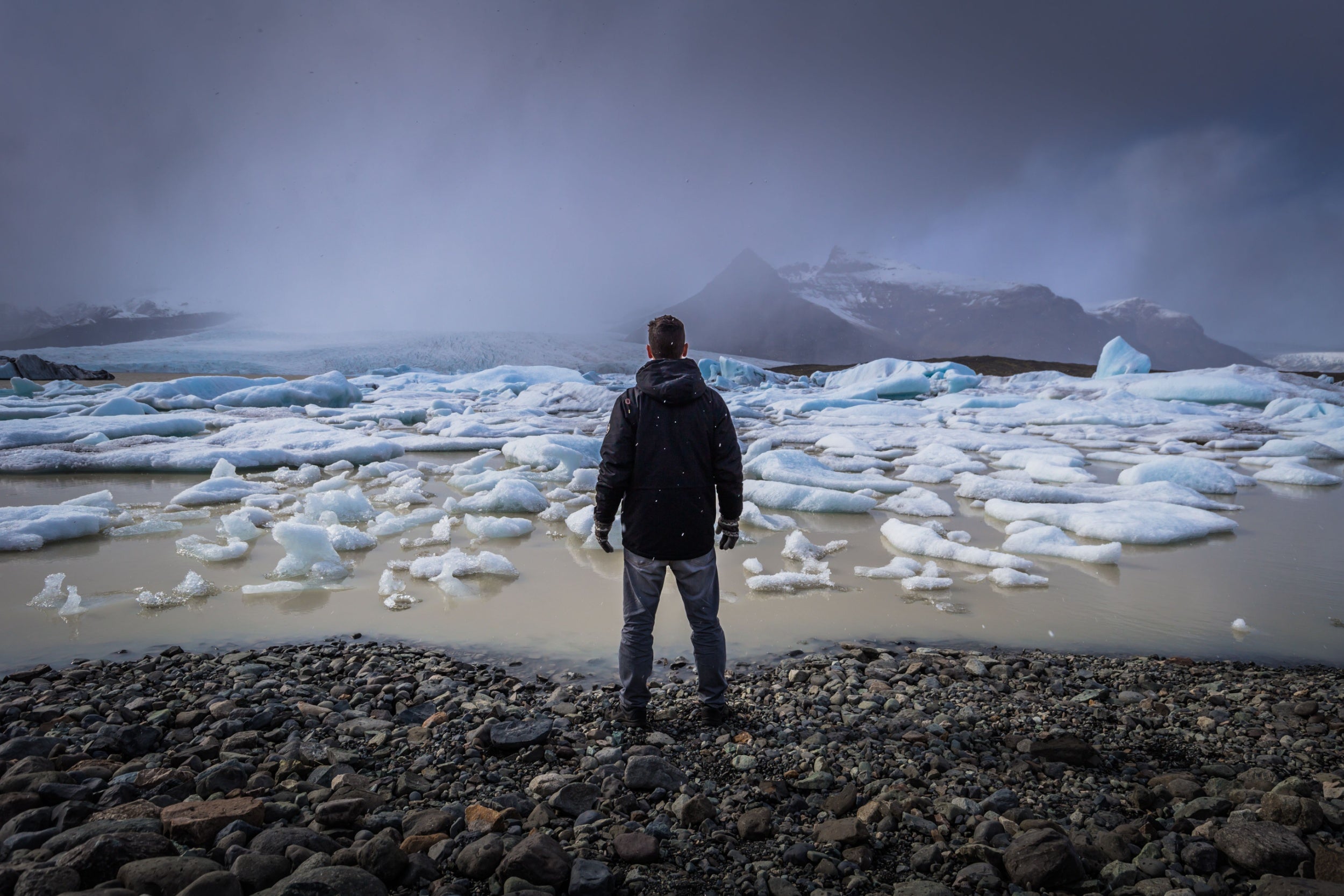 Person overlooking icebergs at Fjallsarlon.