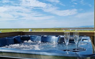 Private outdoor hot tub at Hitarneskot Accommodation with views over the surrounding landscape.