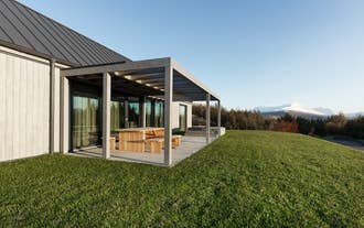 Front view of Heidin Homes Villas in North Iceland with modern design, large windows, and mountain landscapes.
