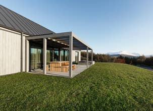 Front view of Heidin Homes Villas in North Iceland with modern design, large windows, and mountain landscapes.