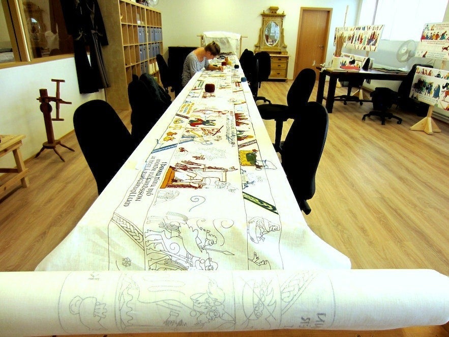 Saga Centre in Hvolsvollur, South Iceland, with Njals Saga embroidery workshop and illustrated storytelling table indoors.