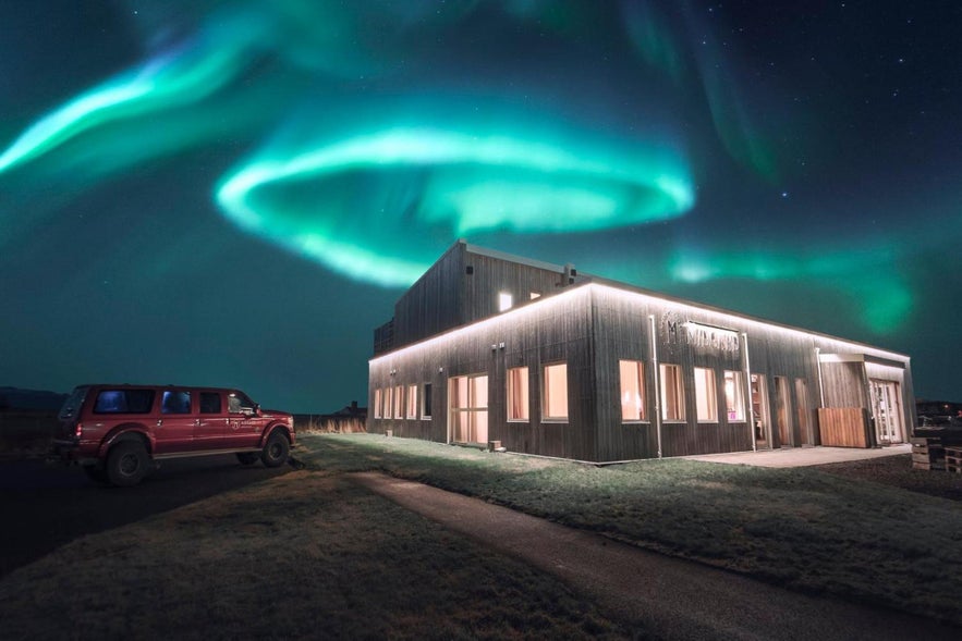 Northern lights over Midgard Base Camp in Hvolsvollur, South Iceland, lodge building at night on the South Coast.