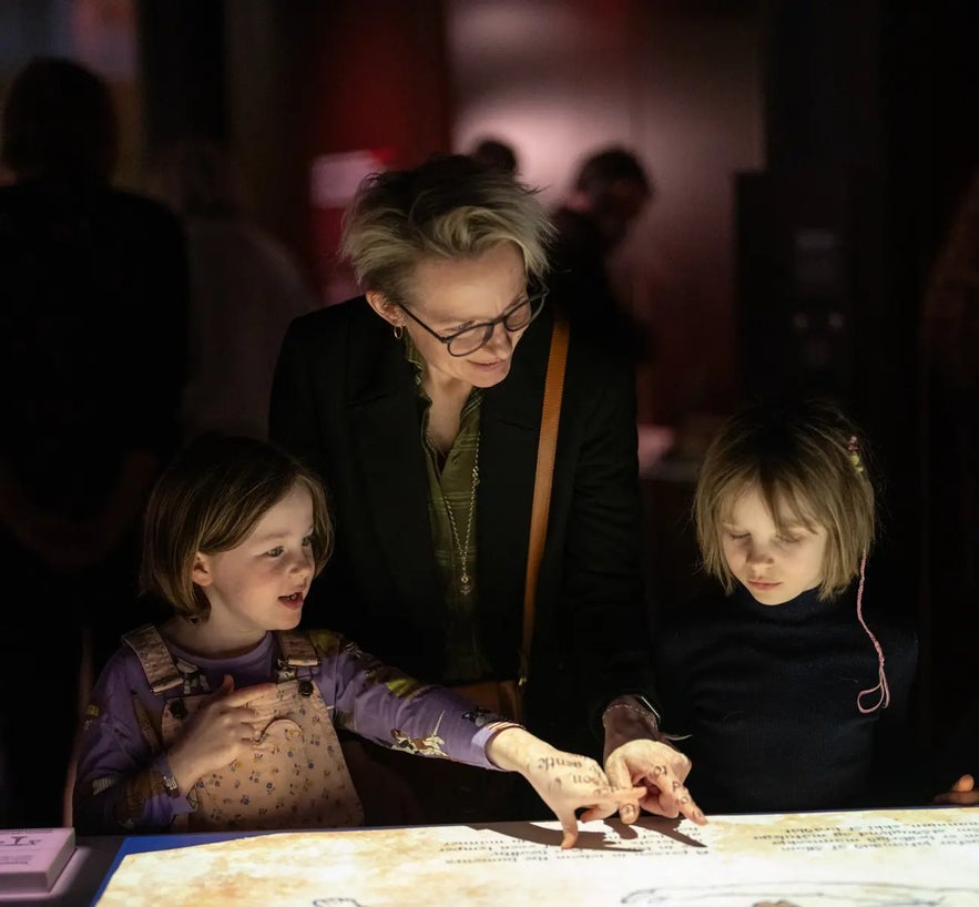 Visitors explore an interactive display at the World in Words exhibition in Reykjavik.