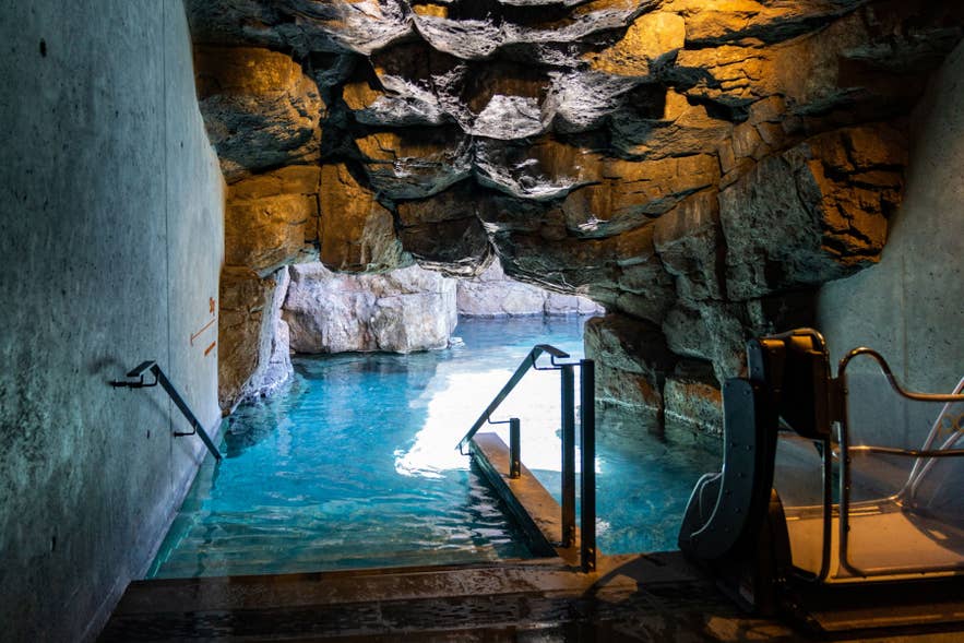 Entrance to Sky Lagoon in Iceland, showing cave-style access leading into warm geothermal waters near Reykjavik
