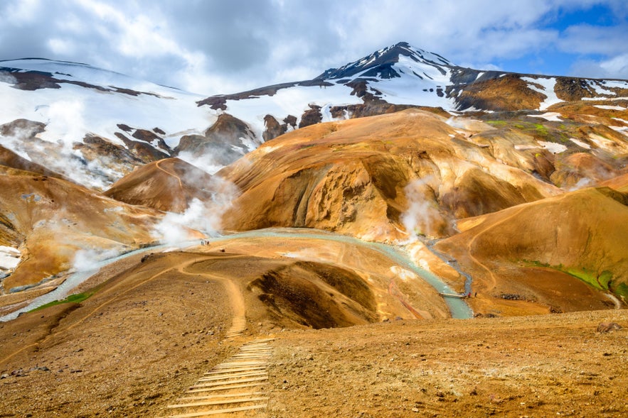 Hveradalir Geothermal Valley in Kerlingarfjoll, Iceland Highlands, with steaming vents, rhyolite mountains, and hiking trail.