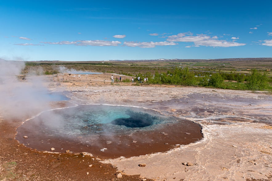 Blesi hot springs in Haukadalur Geothermal Valley, Iceland, with blue and milky geothermal pools.
