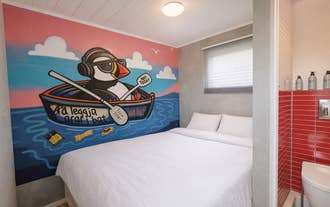 Double room at Truck Inn by Ourhotels with a full-wall mural, cozy bed, and modern interior design.
