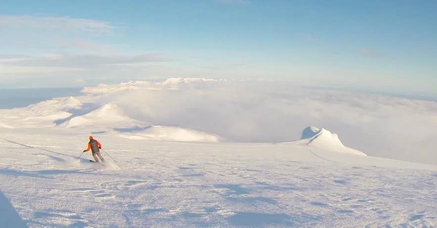 Skiing across an open mountain plateau in Iceland under clear skies. Skiing across an open mountain plateau in Iceland under clear skies.