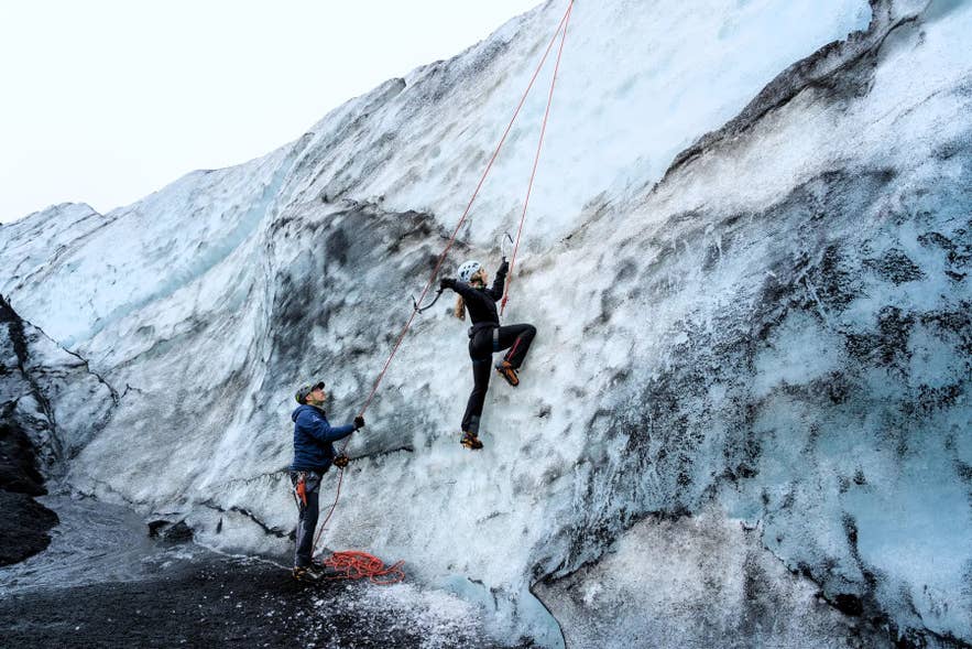 Ice climbing on a glacier wall during a guided adventure in Iceland. Ice climbing on a glacier wall during a guided adventure in Iceland.