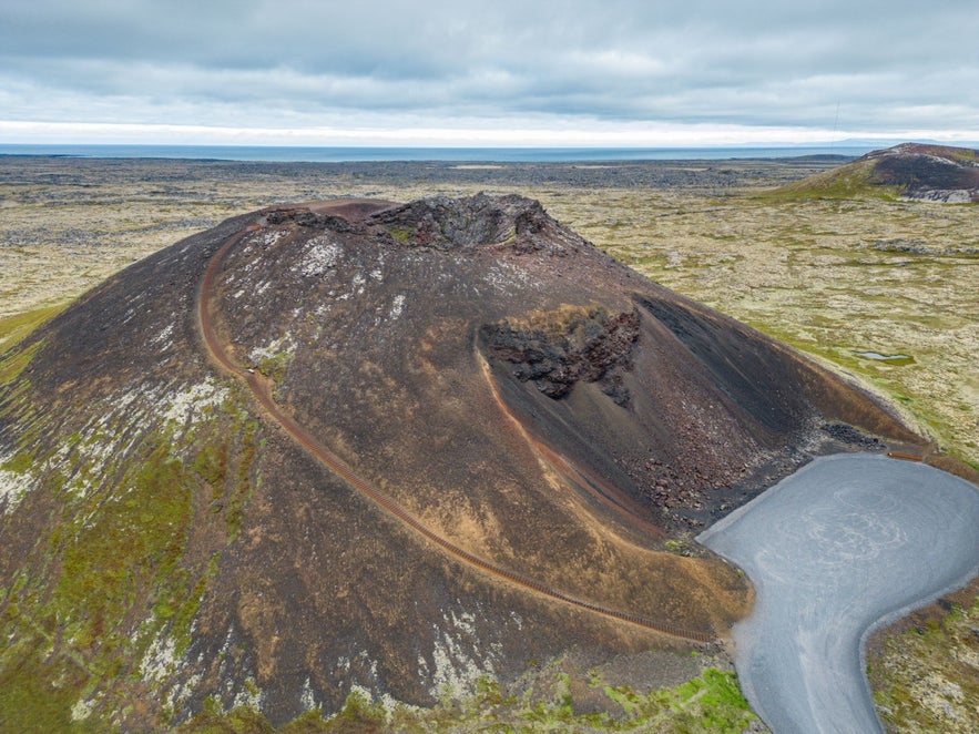 Saxholl Crater and lava fields in Snaefellsjokull National Park, showcasing rugged terrain in West Iceland.