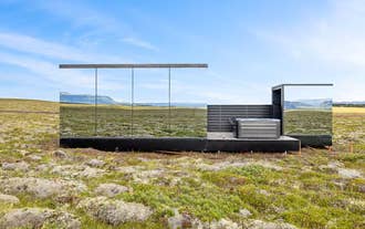Modern Heathland Lodge exterior with glass walls overlooking open Icelandic landscape in the Golden Circle.