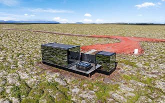 Outdoor seating and jacuzzi beside Heathland Lodge in the scenic Golden Circle in Iceland.