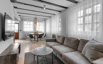 Spacious living room with sofa and modern decor in a luxury apartment in Heart of Reykjavik.