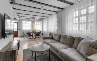 Spacious living room with sofa and modern decor in a luxury apartment in Heart of Reykjavik.