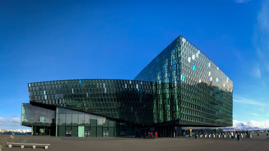 Harpa Concert Hall and Conference Centre in Reykjavik, Iceland, featuring modern glass architecture against a clear blue sky.