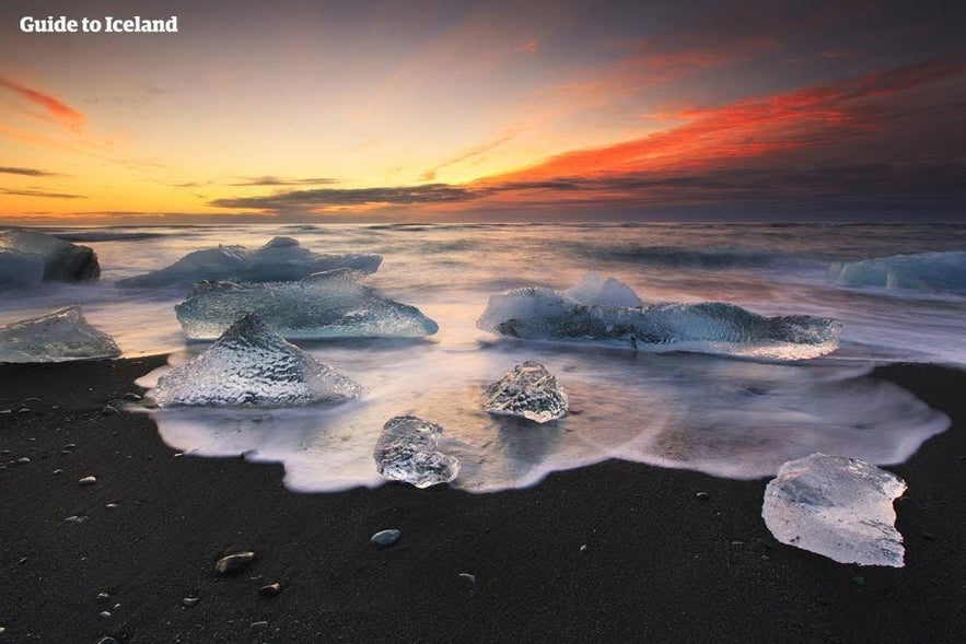 Ice chunks on Diamond Beach near Jokulsarlon Lagoon during the cheapest time to go to Iceland.