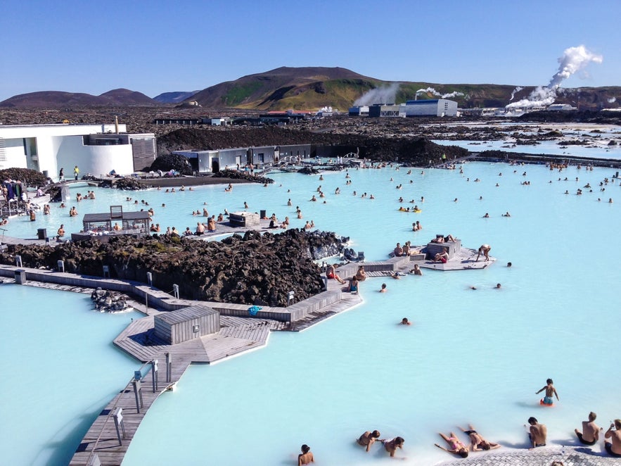 Crowds bathing in the Blue Lagoon near Reykjavik in the cheapest time to go to Iceland.