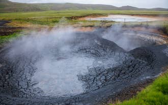 A boiling mud pot venting steam at the Seltun Geothermal Area in Krysuvik.