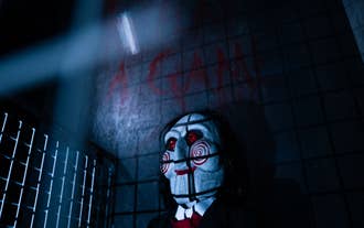 Saw inspired escape room in Reykjavik with masked character and eerie dungeon atmosphere.