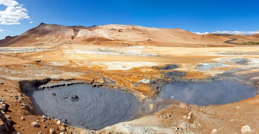 Hverir Geothermal Area near Lake M&yacute;vatn with thick gray mud pools and stark volcanic desert landscape in North Iceland.