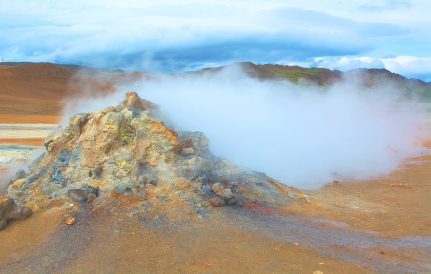 Steam rising from a sulfur-stained geothermal mound at Hverir near Lake Myvatn in North Iceland.