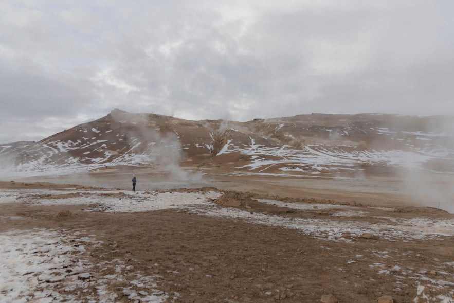 Namaskard in North Iceland with yellow sulfur deposits and rising steam from bubbling geothermal vents.