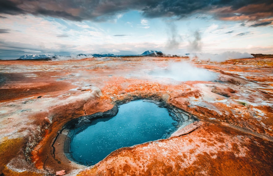 Bubbling mud pool at Namaskard, North Iceland, with vivid yellow sulfur around the edges.