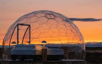 A beautiful sunset behind an igloo at Aurora Igloo North.