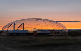 A beautiful sunset behind an igloo at Aurora Igloo North.