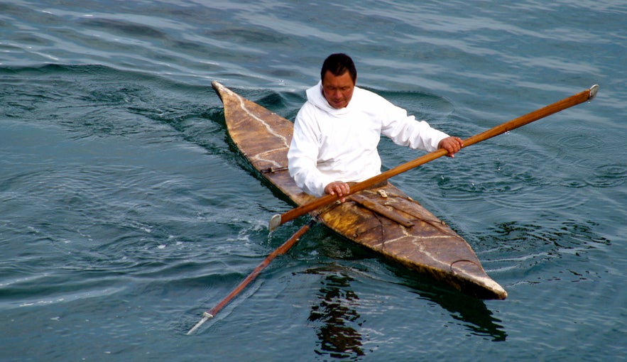 A modern day seal hunter kayaking in Greenland.